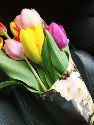 a bouquet of flowers in floral packaging