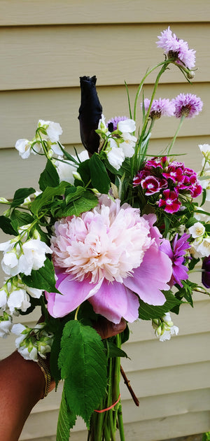 a hand holding a bouquet of flowers