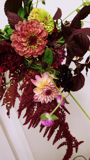 a bouquet of flowers against a white wall