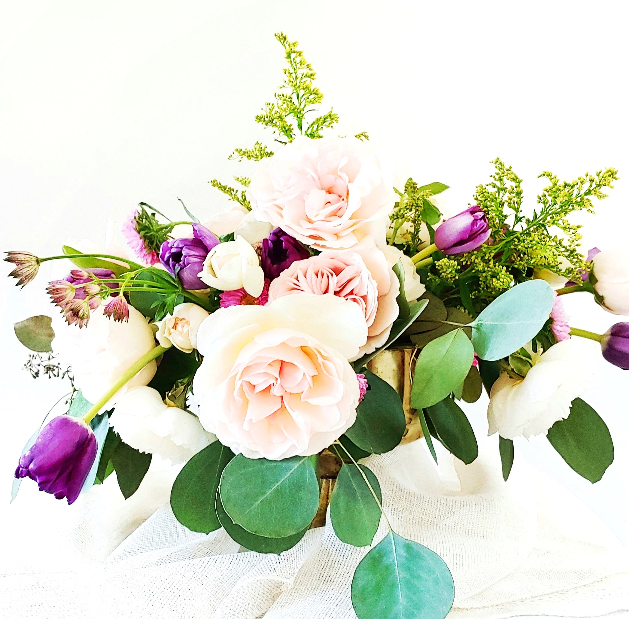 a vase filled with pink and white flowers 