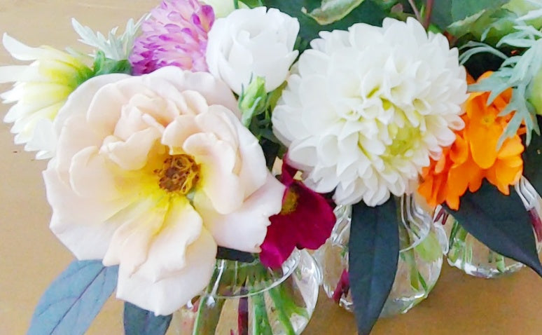 a bouquet of flowers in a vase on a table 