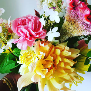 hand held flowers with lots of different colored flowers 