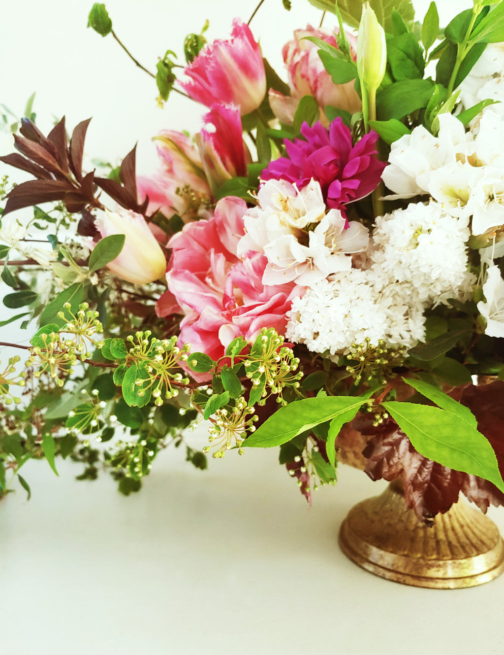 a vase of flowers on a white table 